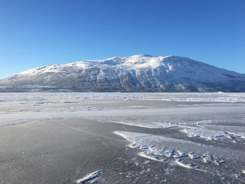 Abisko: Lake Torneträsk Arctic Ice Fishing Trip - Fire, hot drinks, and a wooden hut