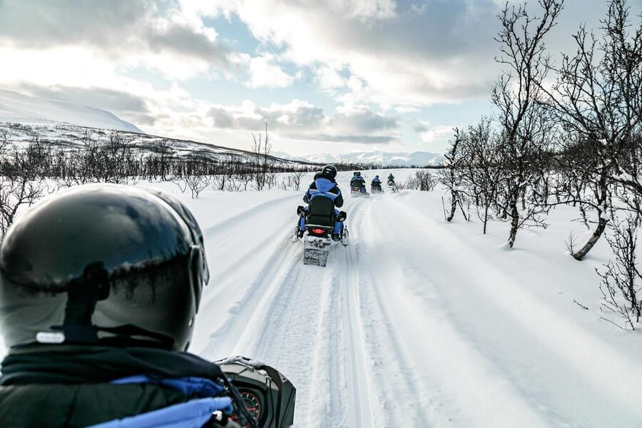 Lyngen: Snowmobile Safari with Lunch in seaside Restaurant - Following the guide into the Lyngen Alps